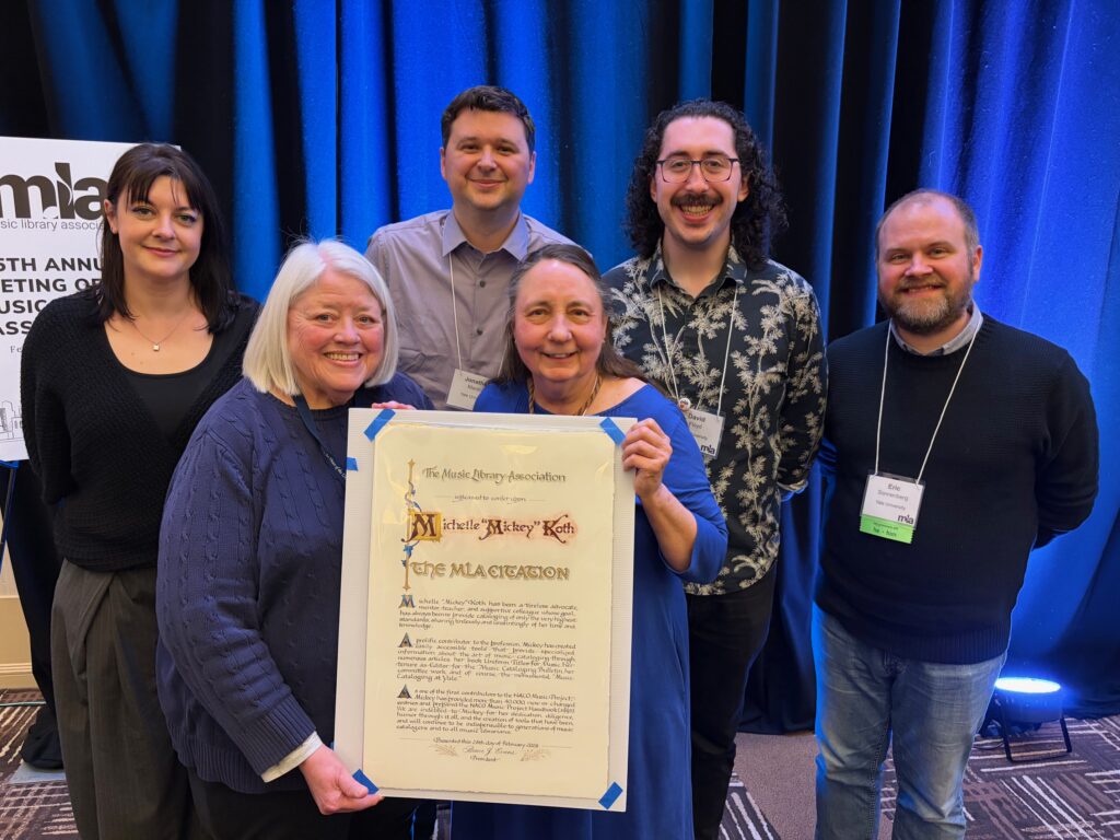 Yale staff surrounding Mickey Koth with her award